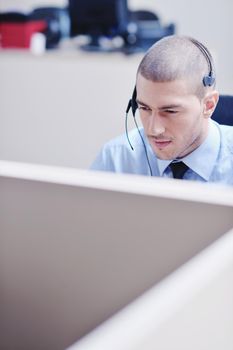 businessman with a headset portrait at bright call center helpdesk support office