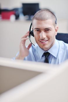 businessman with a headset portrait at bright call center helpdesk support office