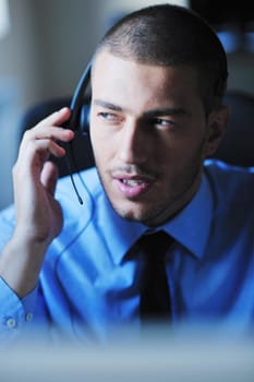 businessman with a headset portrait at bright call center helpdesk support office