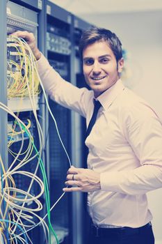 young handsome business man  engeneer in datacenter server room