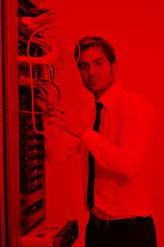 young handsome business man  engeneer in datacenter server room