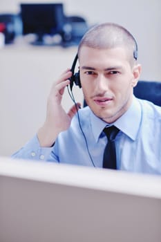 businessman with a headset portrait at bright call center helpdesk support office