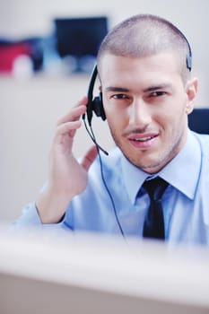 businessman with a headset portrait at bright call center helpdesk support office