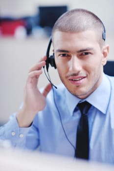 businessman with a headset portrait at bright call center helpdesk support office