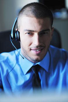 businessman with a headset portrait at bright call center helpdesk support office