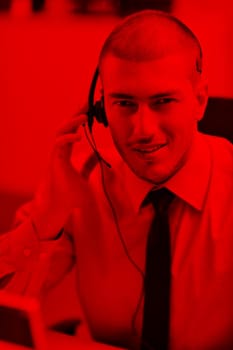 businessman with a headset portrait at bright call center helpdesk support office