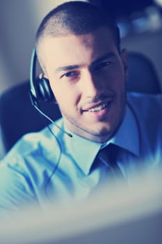 businessman with a headset portrait at bright call center helpdesk support office