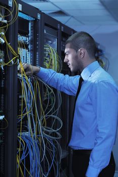 young handsome business man  engeneer in datacenter server room