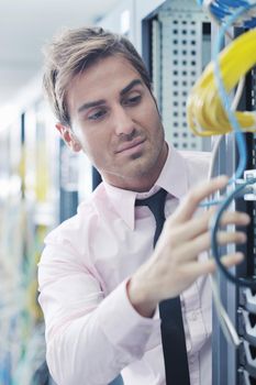 young handsome business man  engeneer in datacenter server room