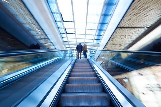 Shopping mall center escalators. Zoom blur movement.