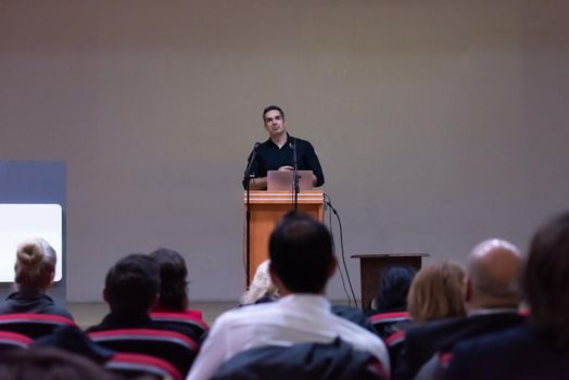 young businessman at business conference room with public giving presentations. Audience at the conference hall. Entrepreneurship club