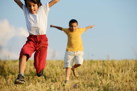 Happy children running on beautiful field