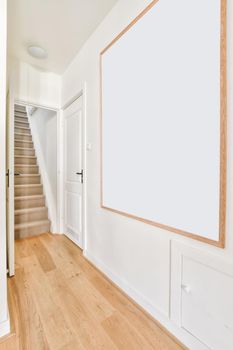 Lovely corridor with wooden parquet floor and staircase