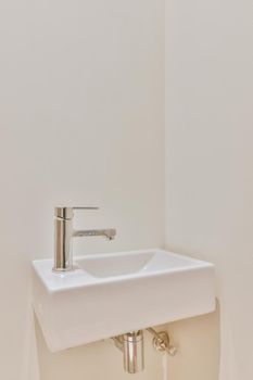Luxurious washroom with beige tiled floor and miniature washbasin