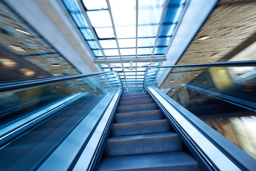 Shopping mall center escalators. Zoom blur movement.