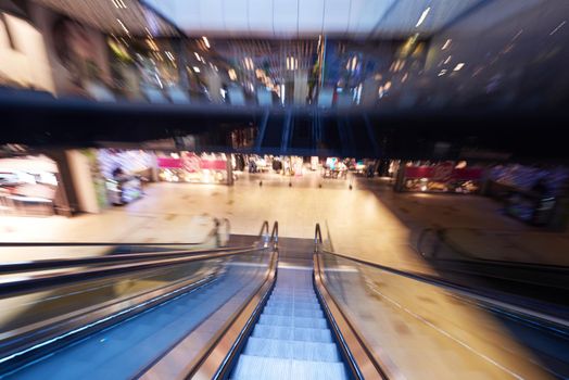 Shopping mall center escalators. Zoom blur movement.