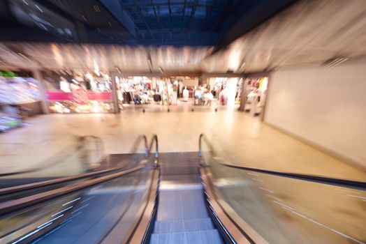 Shopping mall center escalators. Zoom blur movement.