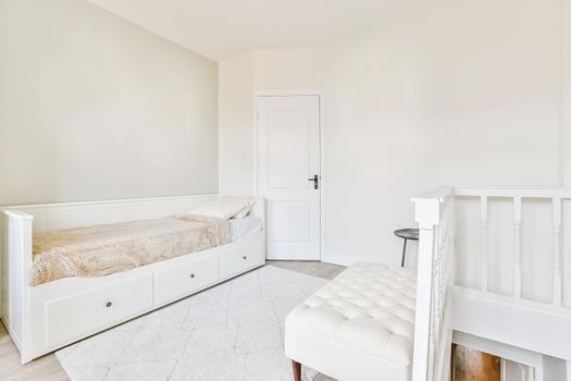 Adorable bright room in daylight with a snow-white ottoman