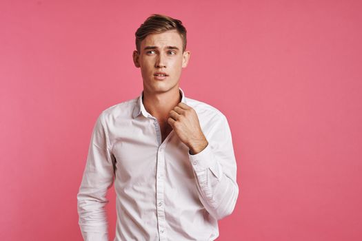 handsome man posing white shirt fashion self confidence pink background. High quality photo