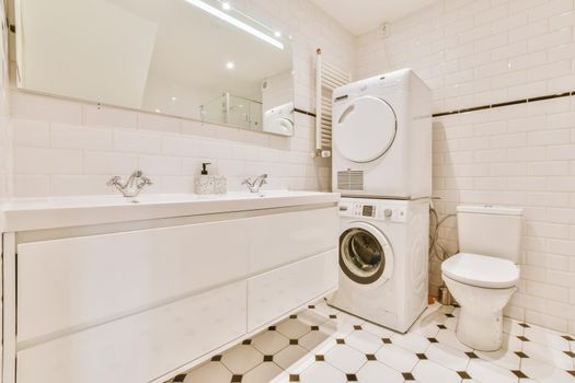 Adorable bathroom with laundry area and large sink for two