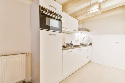 Chic kitchen with white kitchen units and oven