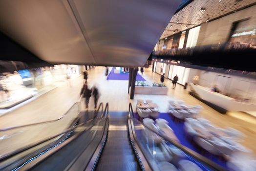 Shopping mall center escalators. Zoom blur movement.