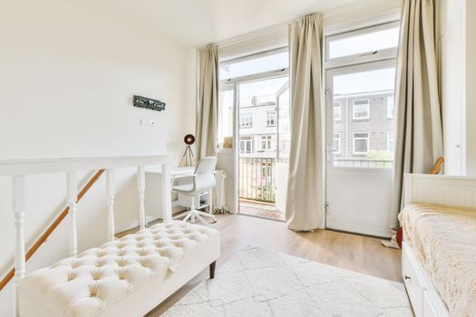 Adorable bright room in daylight with a snow-white ottoman