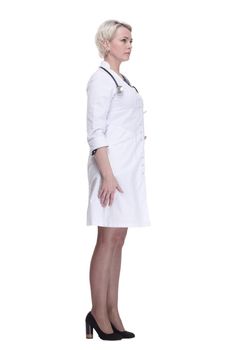 in full growth. young woman doctor looking at you . isolated on a white background.