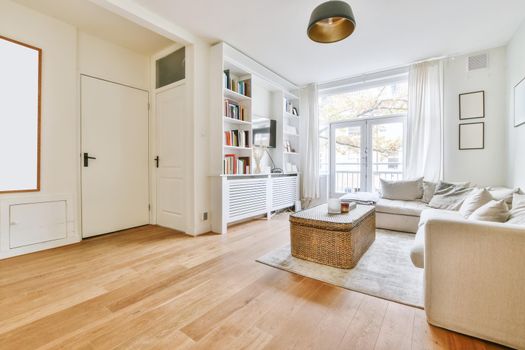 Adorable living room with large soft sofa and wicker coffee table