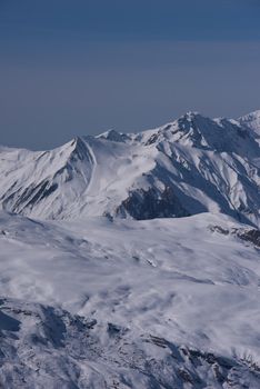 mountain landscape at winter with fresh snow on beautiful sunny day at french alps