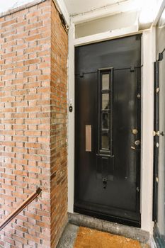 The entrance of the building with a black door