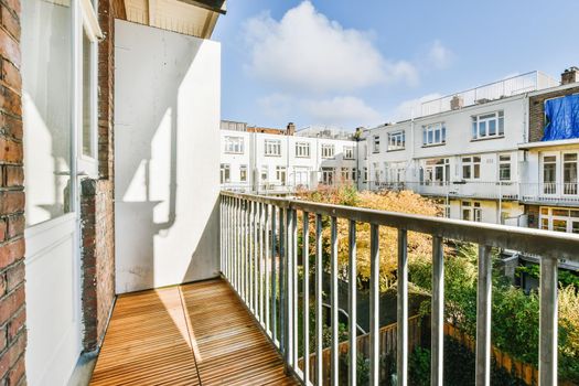 Lovely balcony with iron railings and wooden floor