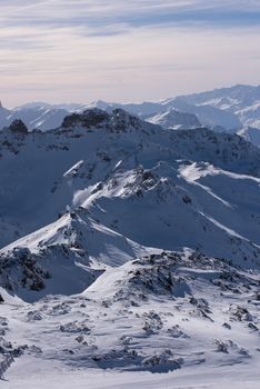 mountain landscape at winter with fresh snow on beautiful sunny day at french alps