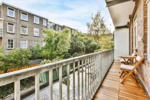 Lovely balcony with iron railings and wooden floor