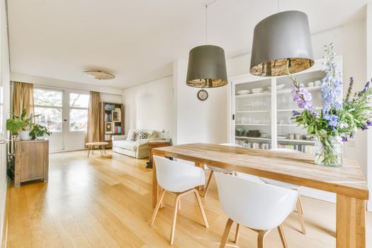 Stylish cozy light dining room with comfortable chairs