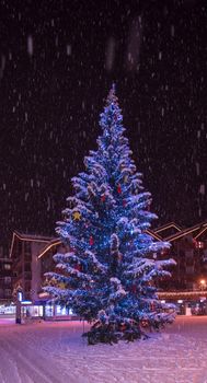 a view on snowy streets of the Alpine mountain village in the cold winter night