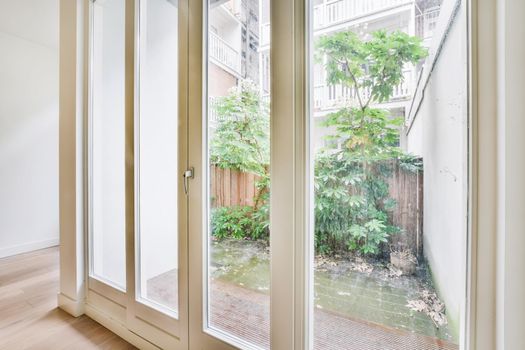 Luxurious glass door with white rim overlooking the courtyard