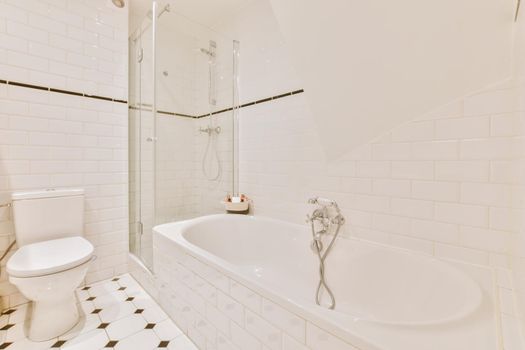 A delightful bathroom with a comfortable bathtub and a shower cubicle with a glass partition