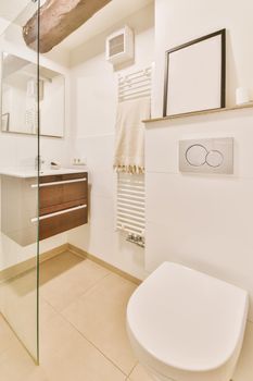 Luxurious restroom with hanging toilet and portrait on the shelf