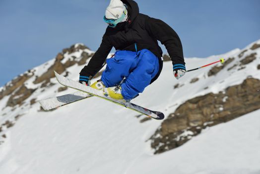 jumping skier at mountain winter snow fresh suny day