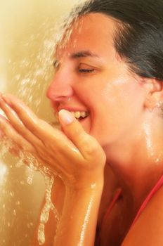 Young beautiful happy smiling tanned brunett woman at  shower in bathroom