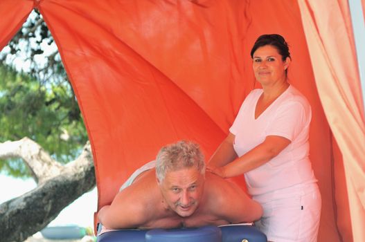 senior man have massage and spa therapy outside