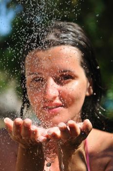 young pretty woman relaxing under shower