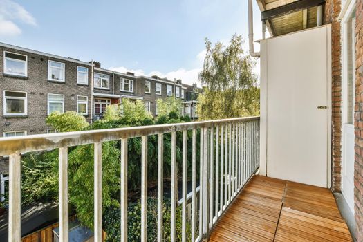 Lovely balcony with iron railings and wooden floor