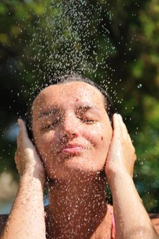 young pretty woman relaxing under shower