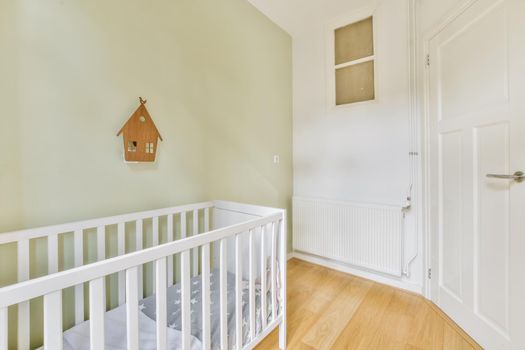 Delightful bright children's room with a small crib