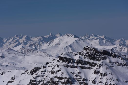 mountain landscape at winter with fresh snow on beautiful sunny day at french alps