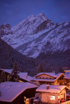 mountain village in alps  at night in winte  with fresh snow