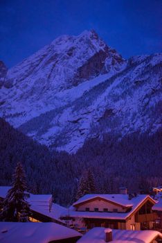 mountain village in alps  at night in winte  with fresh snow