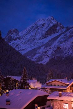 mountain village in alps  at night in winte  with fresh snow